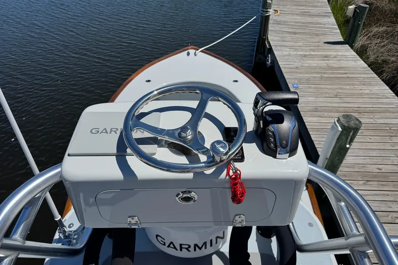 Slide: The Image of 2023 Harrison Boatworks 28 helm with Garmin navigation system and throttle controls. - 5