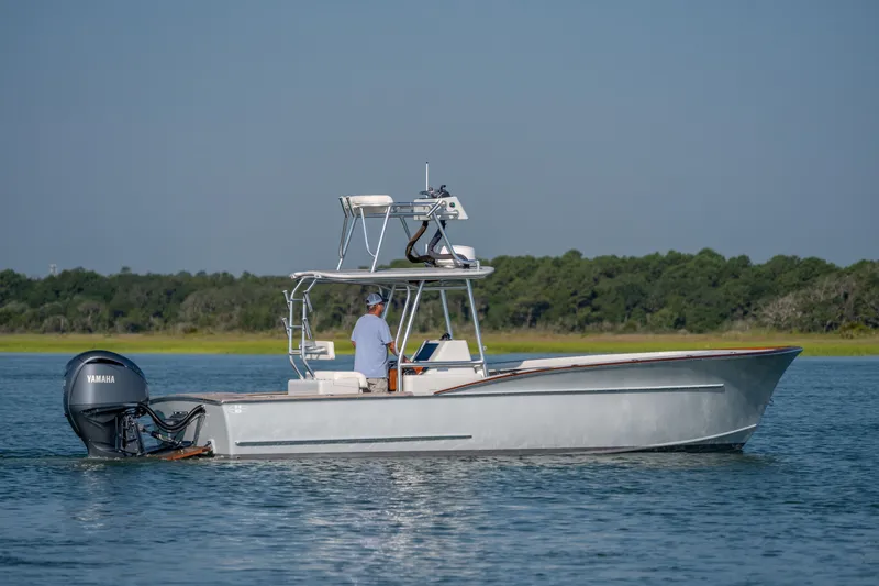 Slide: The Image of 2023 Harrison Boatworks 28 cruising on calm water with Yamaha outboard motor. - 36