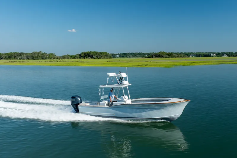 Slide: The Image of 2023 Harrison Boatworks 28 cruising on calm water under clear blue sky. - 19