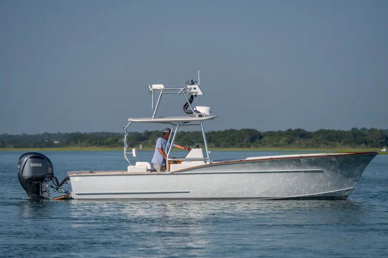 Slide: The Image of 2023 Harrison Boatworks 28 on calm water, featuring a Yamaha outboard motor. - 42