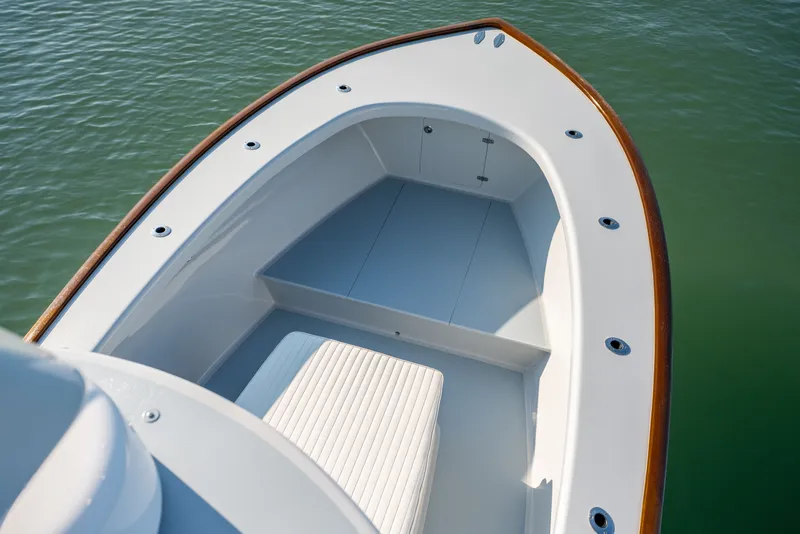 Slide: The Image of 2023 Harrison Boatworks 28 bow, featuring sleek design and spacious seating on calm water. - 27