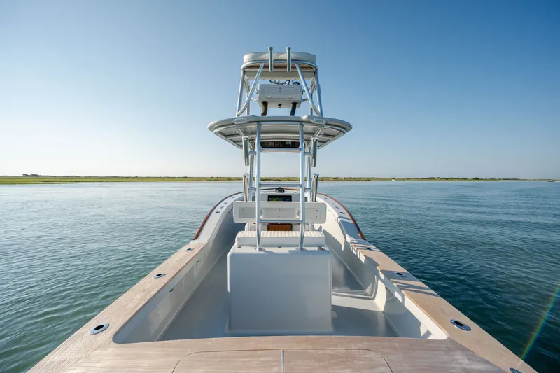 Slide: The Image of 2023 Harrison Boatworks 28 on calm water, showcasing sleek design and spacious deck. - 38
