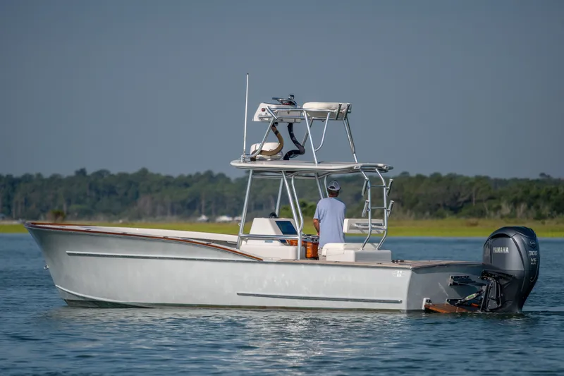 Slide: The Image of 2023 Harrison Boatworks 28 on water, featuring Yamaha outboard motor. - 2