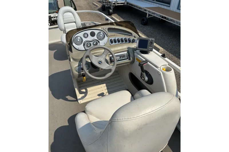 Slide: The Image of 2008 Crestliner Batata Bay 2185 boat dashboard with steering wheel and controls. - 15