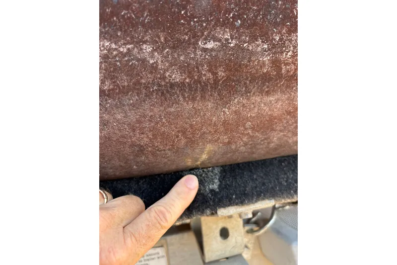 Slide: The Image of Finger pointing at rust on 2008 Crestliner Batata Bay 2185 boat hull. - 21