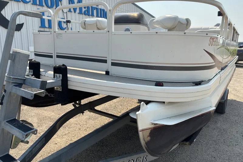Slide: The Image of 2008 Crestliner Batata Bay 2185 pontoon boat on trailer, parked outdoors. - 8