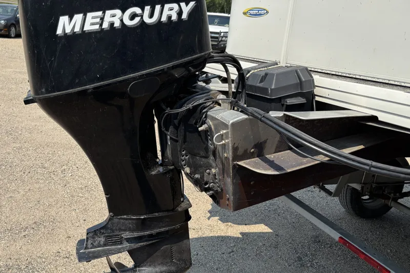 Slide: The Image of Mercury outboard motor on 2008 Crestliner Batata Bay 2185 boat, parked on gravel. - 3