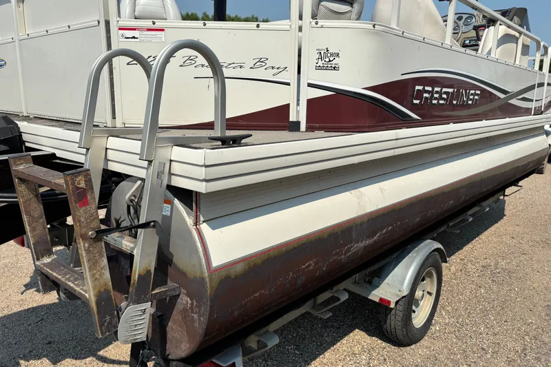 Slide: The Image of 2008 Crestliner Batata Bay 2185 pontoon boat on trailer, featuring rear ladder. - 4