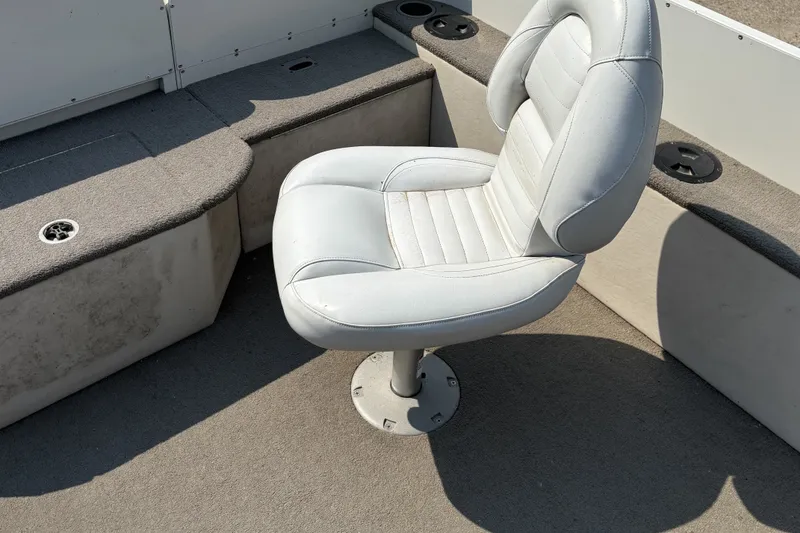 Slide: The Image of 2008 Crestliner Batata Bay 2185 boat interior with swivel seat and carpeted flooring. - 17