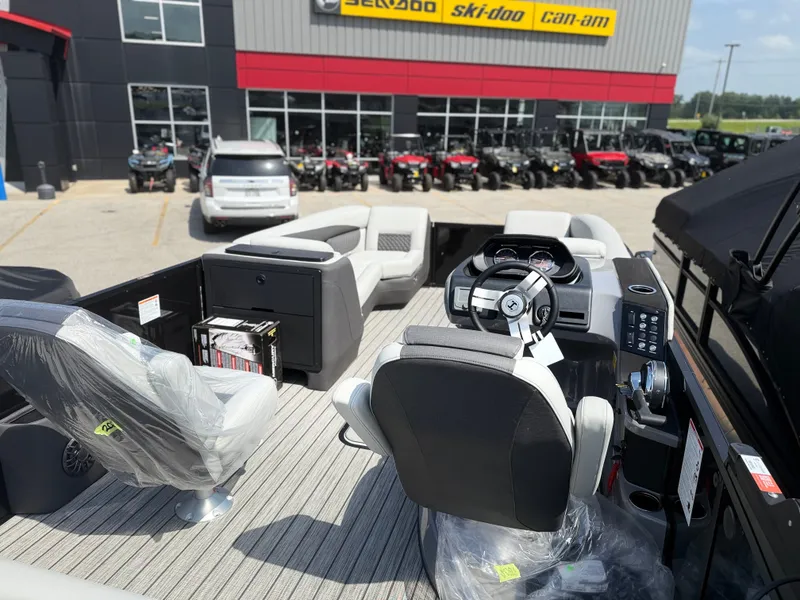 Slide: The Image of The image shows the interior of a 2027 Harris FloteBote SUNLINER 230 TRI-TOON SLDH. It features modern seating and a sleek dashboard. - 6