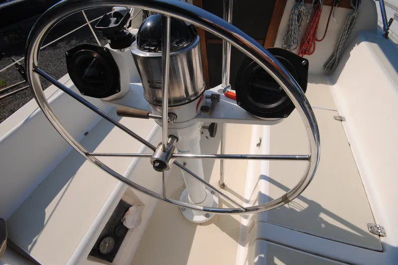 Slide: The Image of Steering wheel of a 1987 Tillotson-Pearson 28 sailboat, featuring navigation instruments. - 9