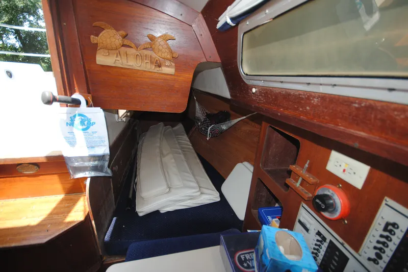 Slide: The Image of Interior of 1987 Tillotson-Pearson 28 sailboat with wooden paneling and nautical decor. - 15