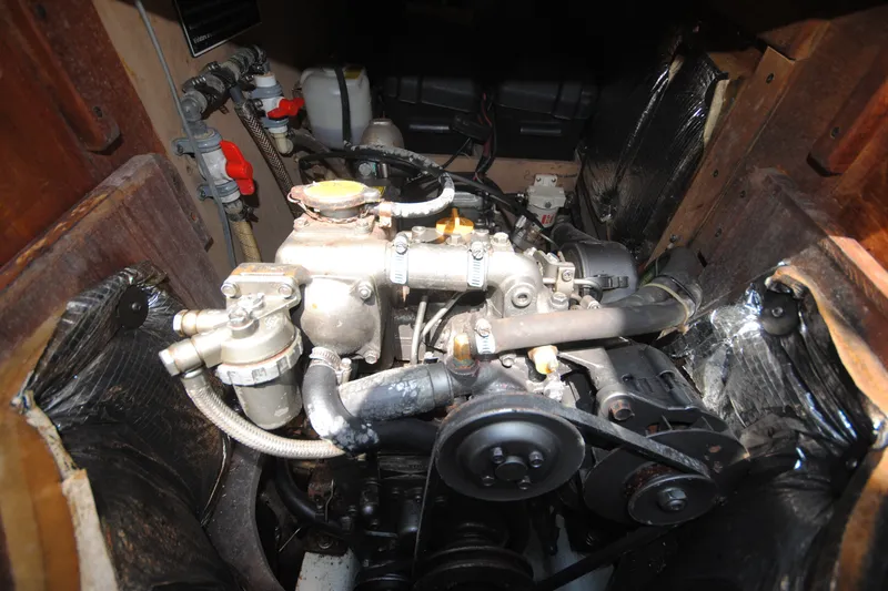 Slide: The Image of Engine compartment of a 1987 Tillotson-Pearson 28, showcasing mechanical components and hoses. - 20