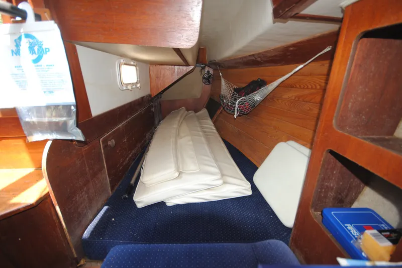 Slide: The Image of Interior of a 1987 Tillotson-Pearson 28 sailboat with cushions and storage net. - 16