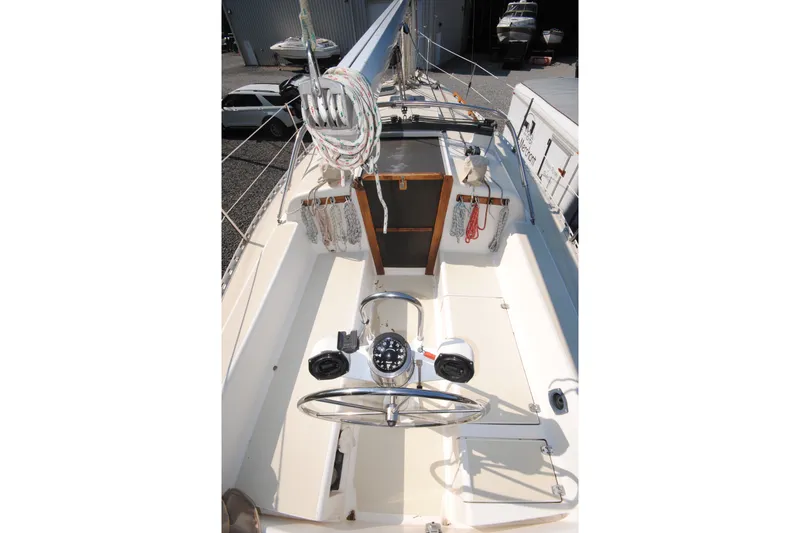 Slide: The Image of 1987 Tillotson-Pearson 28 sailboat cockpit with steering wheel and rigging details. - 8