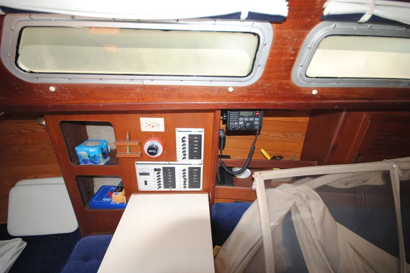 Slide: The Image of Interior of a 1987 Tillotson-Pearson 28 sailboat with control panels and storage compartments. - 14