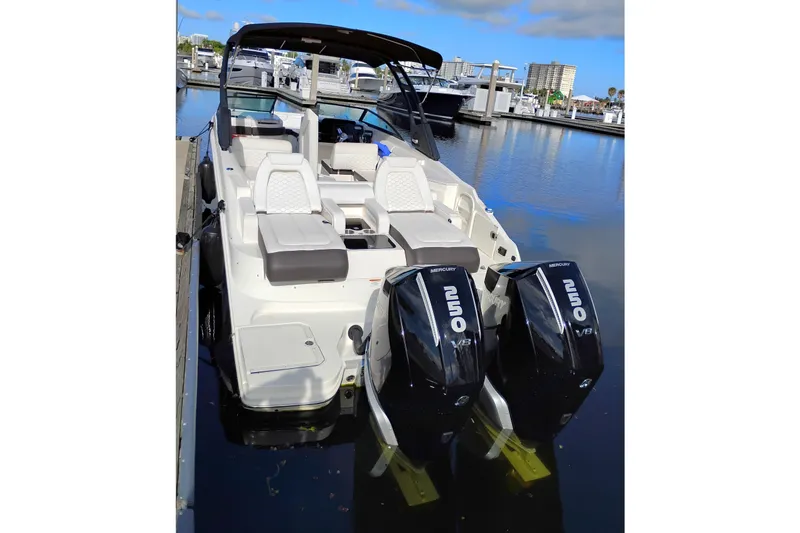 Slide: The Image of 2025 Sea Ray SDX 290 Outboard boat docked, featuring dual Mercury V8 engines. - 1