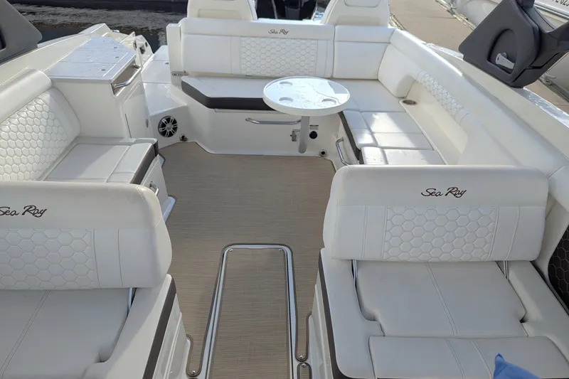 Slide: The Image of 2025 Sea Ray SDX 290 Outboard boat interior with luxurious white seating and table. - 4