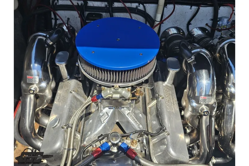 Slide: The Image of Engine of a 2001 Advantage 34 Offshore boat with blue air filter and chrome components. - 88