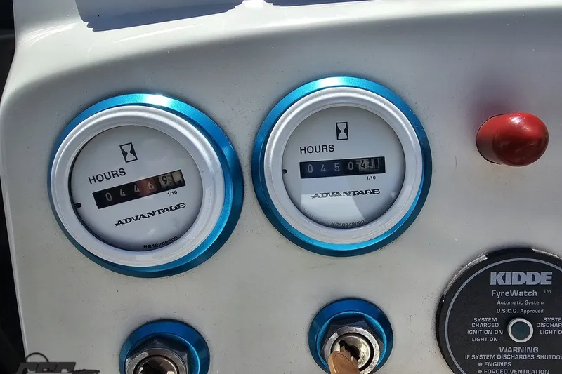 Slide: The Image of Dashboard of a 2001 Advantage 34 Offshore boat showing hour meters and ignition keys. - 59