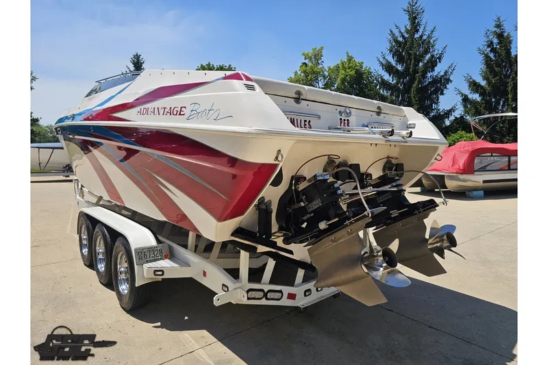 Slide: The Image of 2001 Advantage 34 Offshore boat on trailer, featuring vibrant red and blue design. - 25