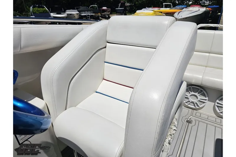 Slide: The Image of White leather seat on 2001 Advantage 34 Offshore boat, featuring blue and red accents. - 78