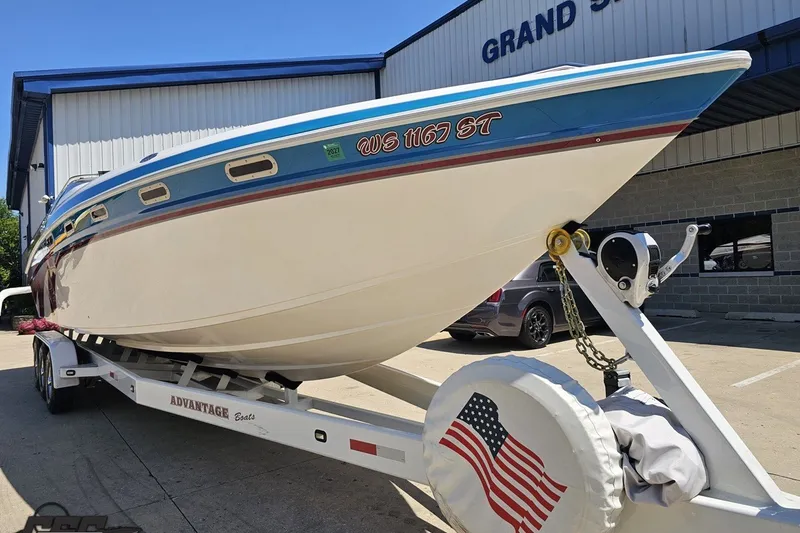 Slide: The Image of 2001 Advantage 34 Offshore boat on trailer, parked outside a building. - 14