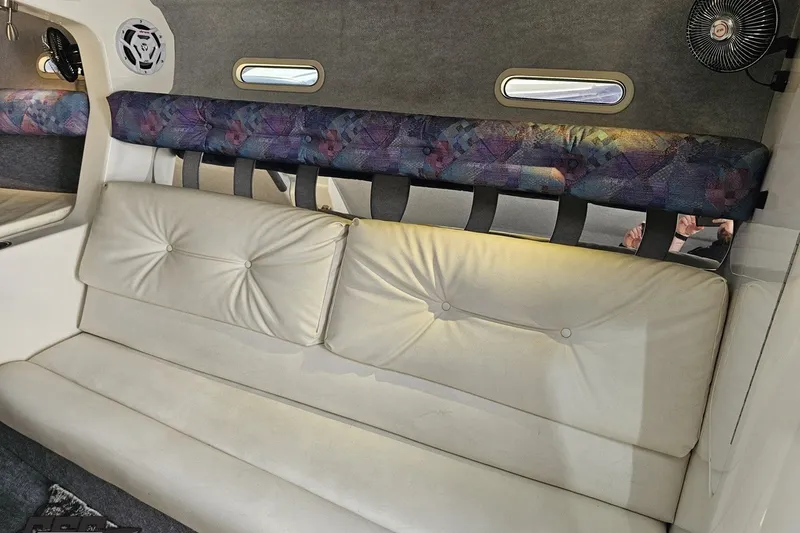 Slide: The Image of Interior of 2001 Advantage 34 Offshore boat with white seating and patterned accents. - 66