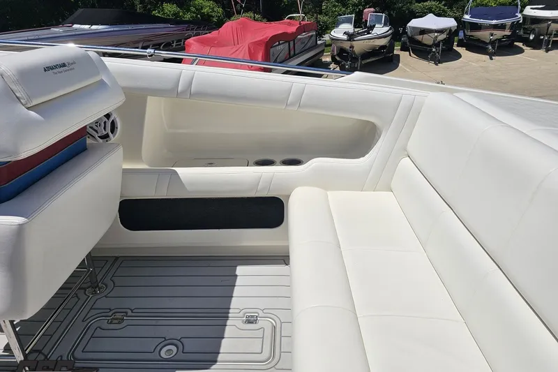 Slide: The Image of 2001 Advantage 34 Offshore boat interior with white seating and cup holders. - 44
