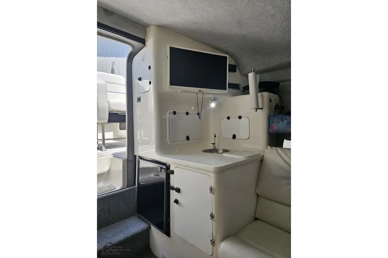 Slide: The Image of Interior of 2001 Advantage 34 Offshore boat with kitchenette and seating area. - 69
