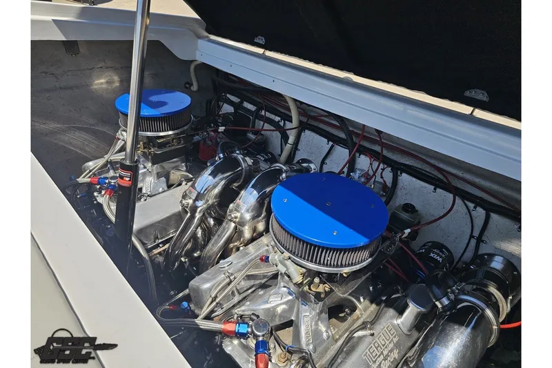 Slide: The Image of Engine compartment of a 2001 Advantage 34 Offshore boat with dual engines and blue air filters. - 86