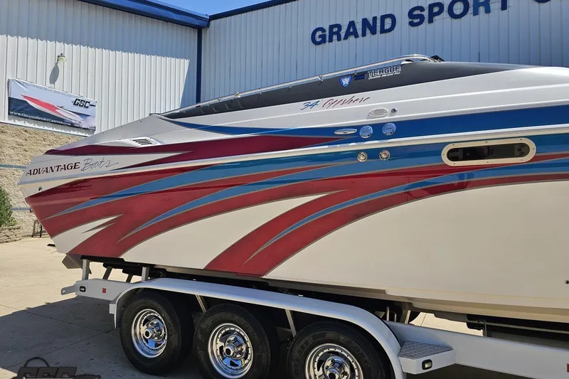 Slide: The Image of 2001 Advantage 34 Offshore boat with vibrant red and blue design, displayed at Grand Sport Center. - 7