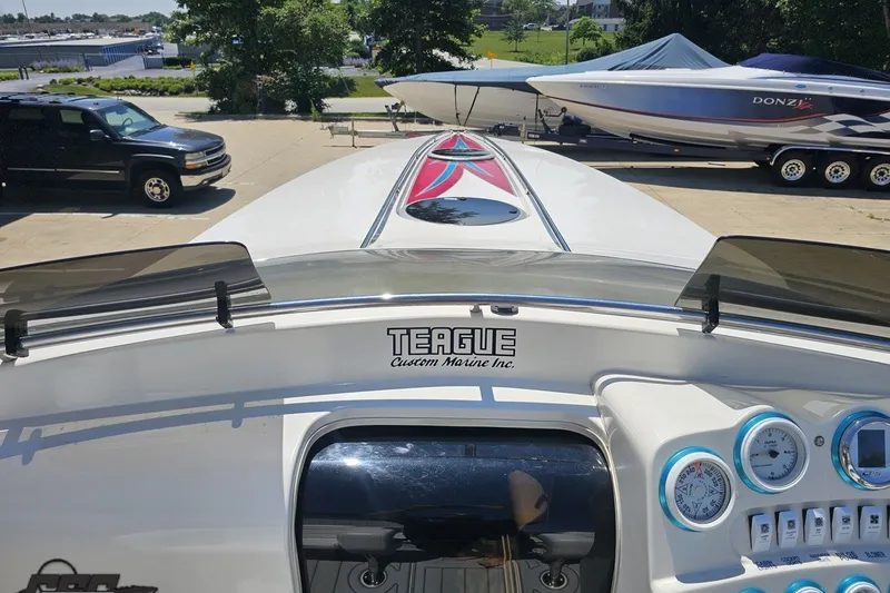 Slide: The Image of 2001 Advantage 34 Offshore boat dashboard with Teague Custom Marine branding and gauges. - 60