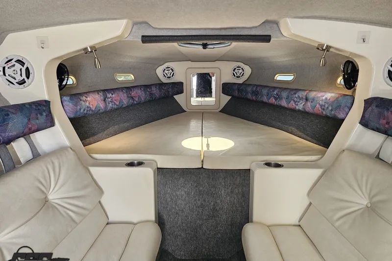 Slide: The Image of Interior of a 2001 Advantage 34 Offshore boat, featuring cushioned seating and compact design. - 65