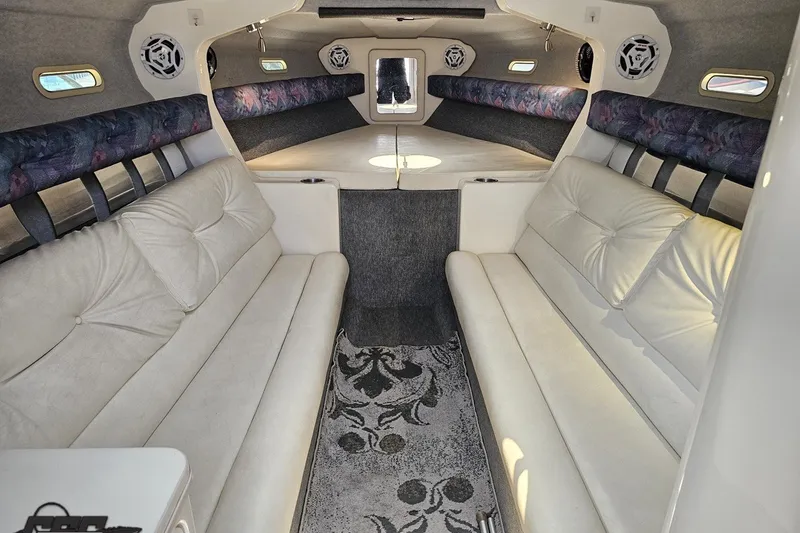 Slide: The Image of Interior of a 2001 Advantage 34 Offshore boat with white seating and patterned carpet. - 64