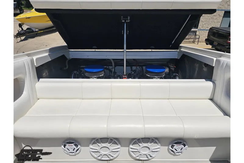 Slide: The Image of 2001 Advantage 34 Offshore boat engine compartment with white seating and dual engines. - 84