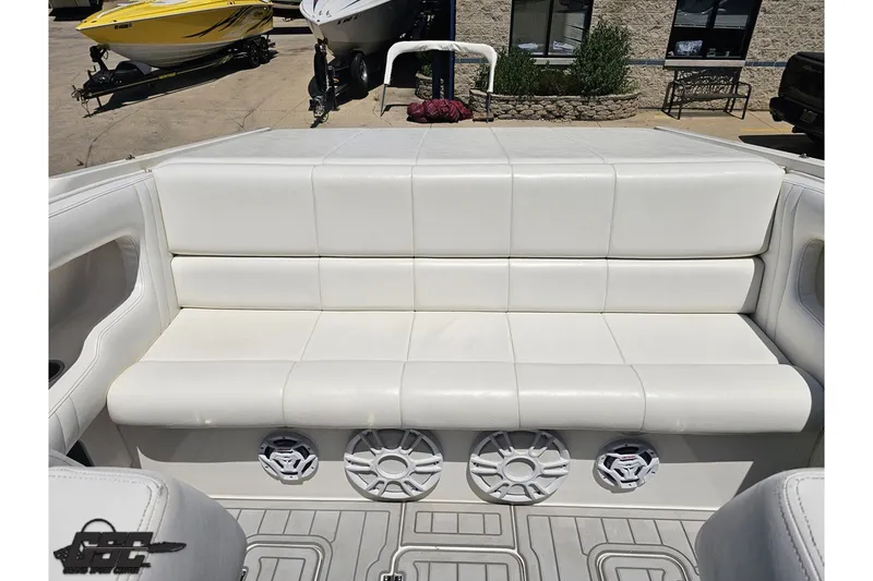 Slide: The Image of White leather seating on a 2001 Advantage 34 Offshore boat, featuring built-in speakers. - 79