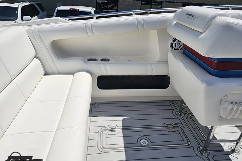 Slide: The Image of 2001 Advantage 34 Offshore boat interior with white seating and cup holders. - 49