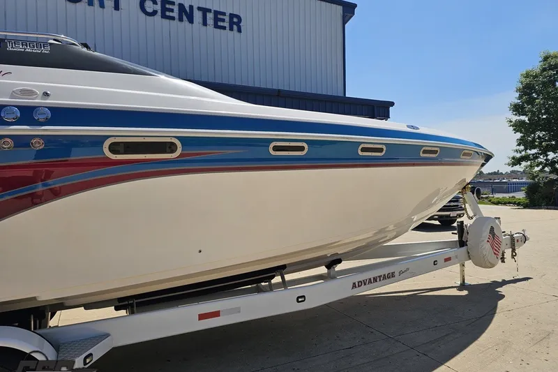 Slide: The Image of 2001 Advantage 34 Offshore boat on trailer, featuring blue and red accents. - 6