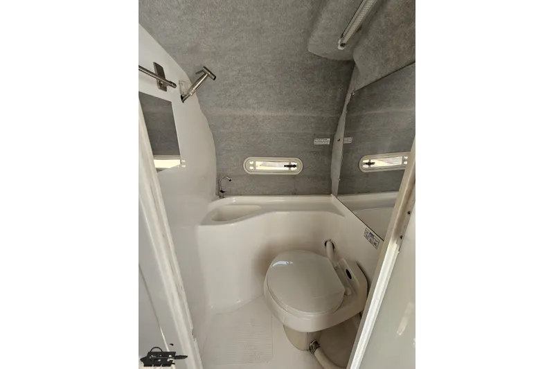 Slide: The Image of 2001 Advantage 34 Offshore boat bathroom with compact toilet and shower. - 73