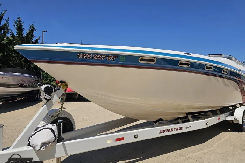 Slide: The Image of 2001 Advantage 34 Offshore boat on trailer, showcasing sleek design and vibrant colors. - 15