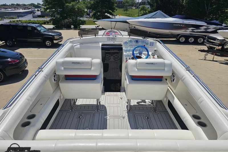 Slide: The Image of 2001 Advantage 34 Offshore boat interior with white seating and blue steering wheel. - 39