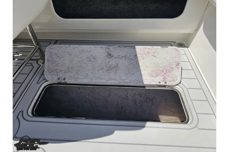 Slide: The Image of Open storage compartment on 2001 Advantage 34 Offshore boat deck. - 83