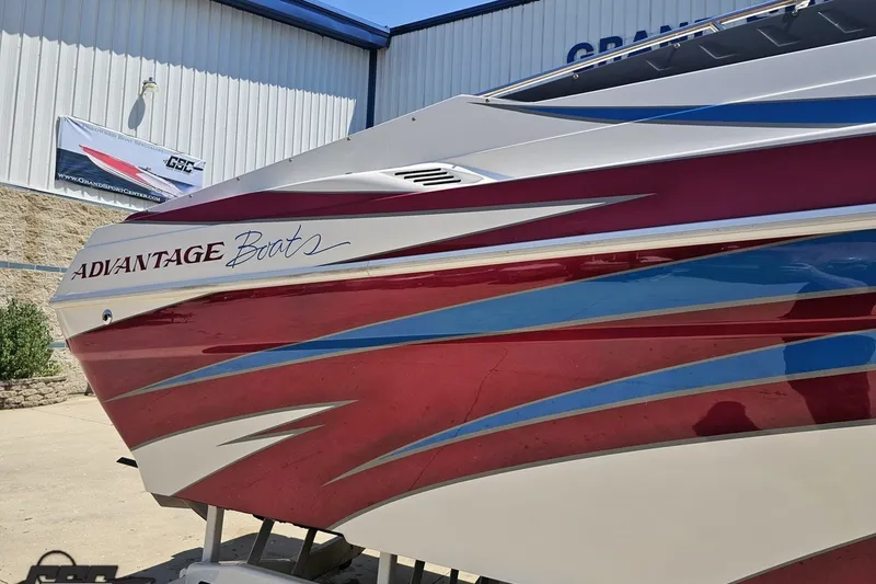 Slide: The Image of 2001 Advantage 34 Offshore boat with red and blue graphics, displayed outdoors. - 8