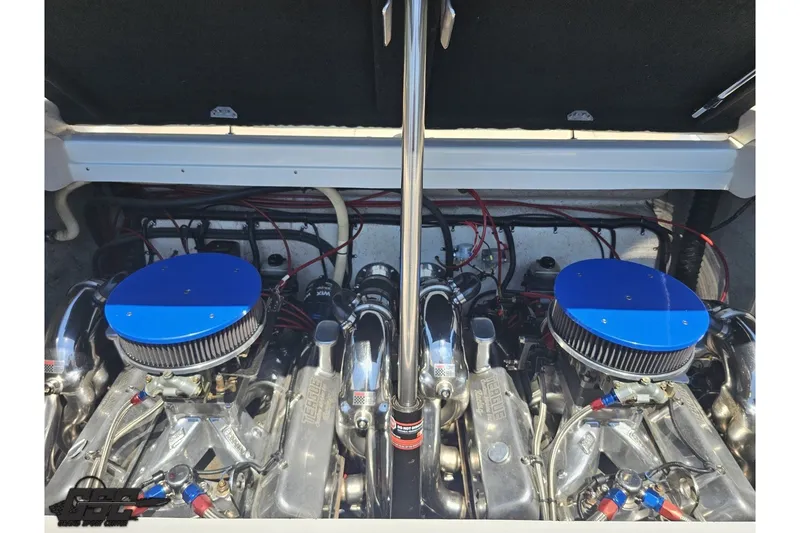 Slide: The Image of Engine compartment of a 2001 Advantage 34 Offshore boat, featuring dual engines with blue air filters. - 85