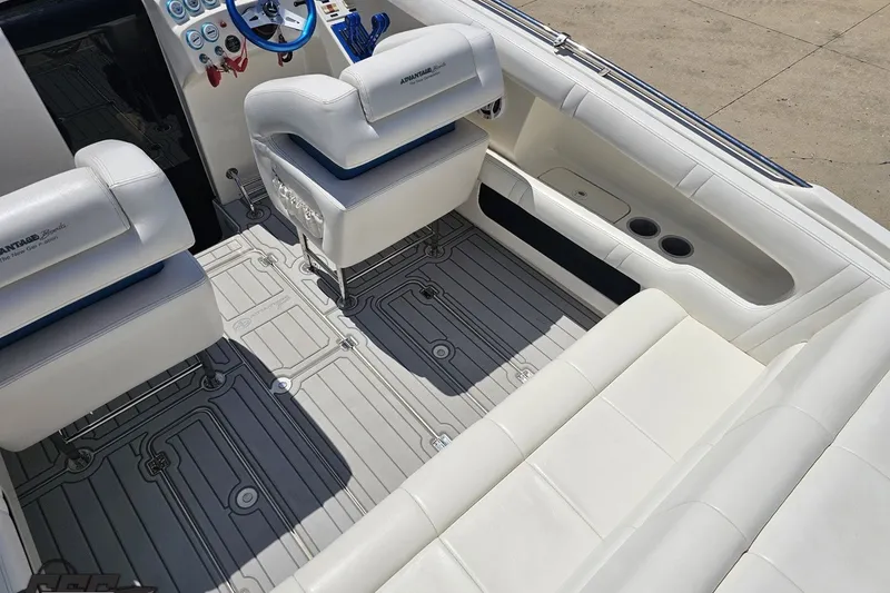 Slide: The Image of Interior of a 2001 Advantage 34 Offshore boat with white seating and modern dashboard. - 43