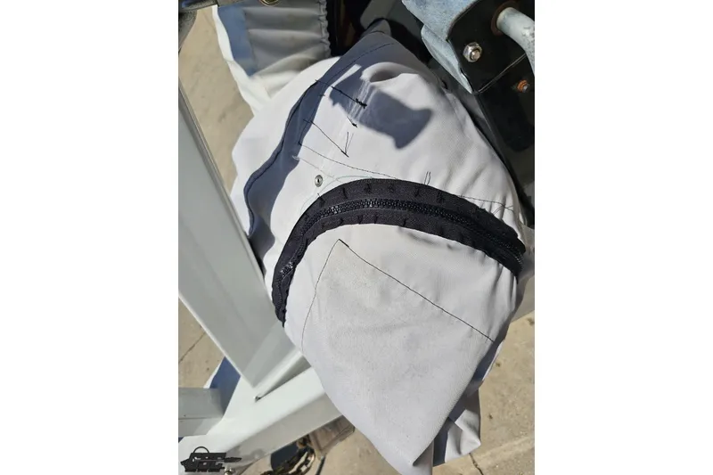 Slide: The Image of Close-up of a white fabric with a black zipper on a 2001 Advantage 34 Offshore boat. - 93