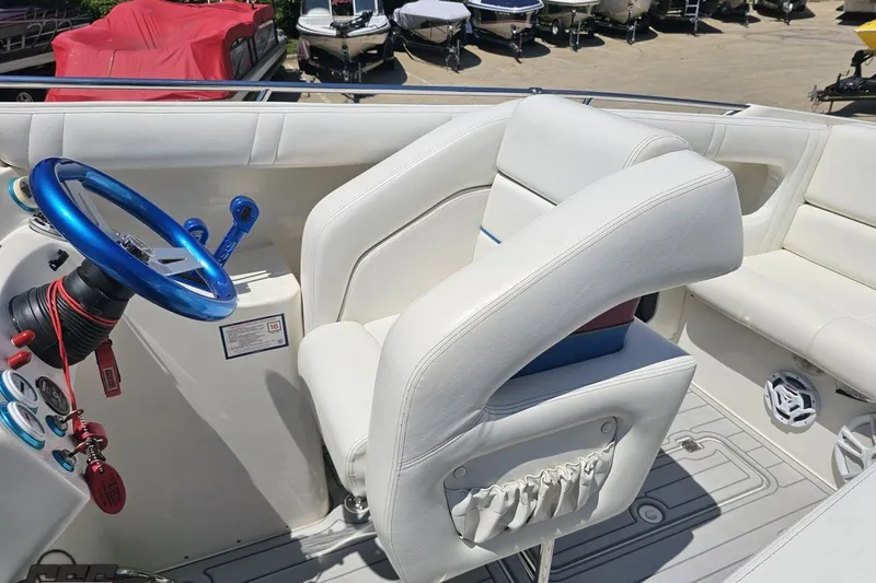 Slide: The Image of Interior of 2001 Advantage 34 Offshore boat with white seating and blue steering wheel. - 52
