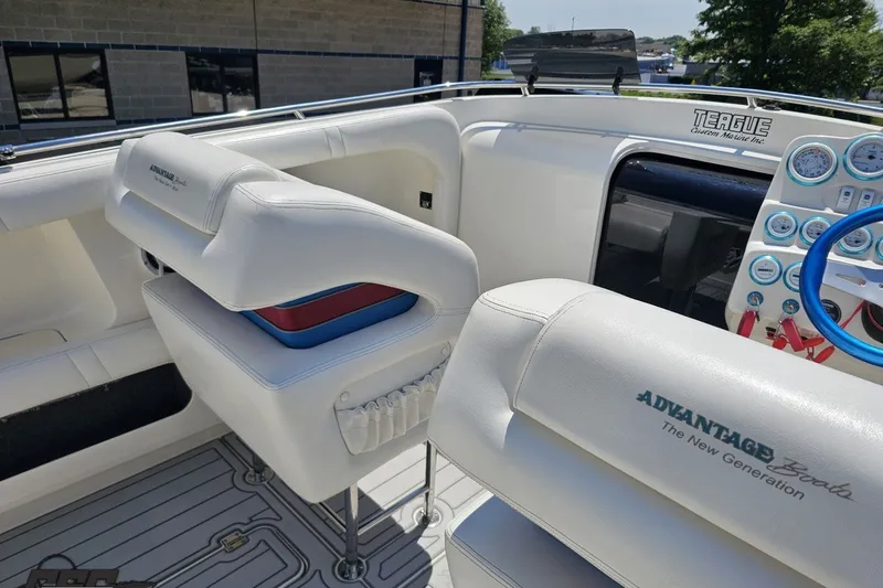 Slide: The Image of Interior of 2001 Advantage 34 Offshore boat with white seating and blue steering wheel. - 50
