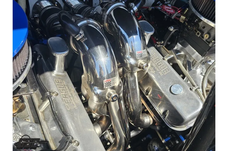 Slide: The Image of Engine components of a 2001 Advantage 34 Offshore boat, featuring polished metal parts. - 89